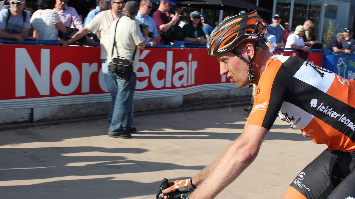 A Roompot-Nederlandse Loterij rider heads to the team buses