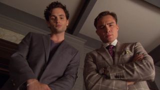 Penn Badgley as Dan Humphrey and Ed Westwick as Chuck Bass look down at something on Gossip Girl Season 5, Episode 3.