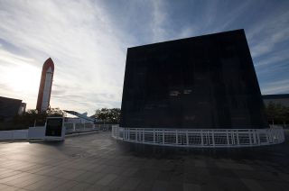 Early morning sunlight illuminates the names on the Space Mirror Memorial at Kennedy Space Center Visitor Complex in Florida