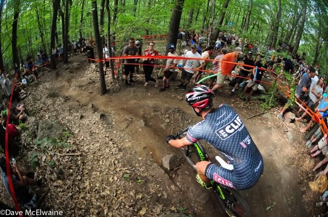 A Clif Bar rider descending through the woods