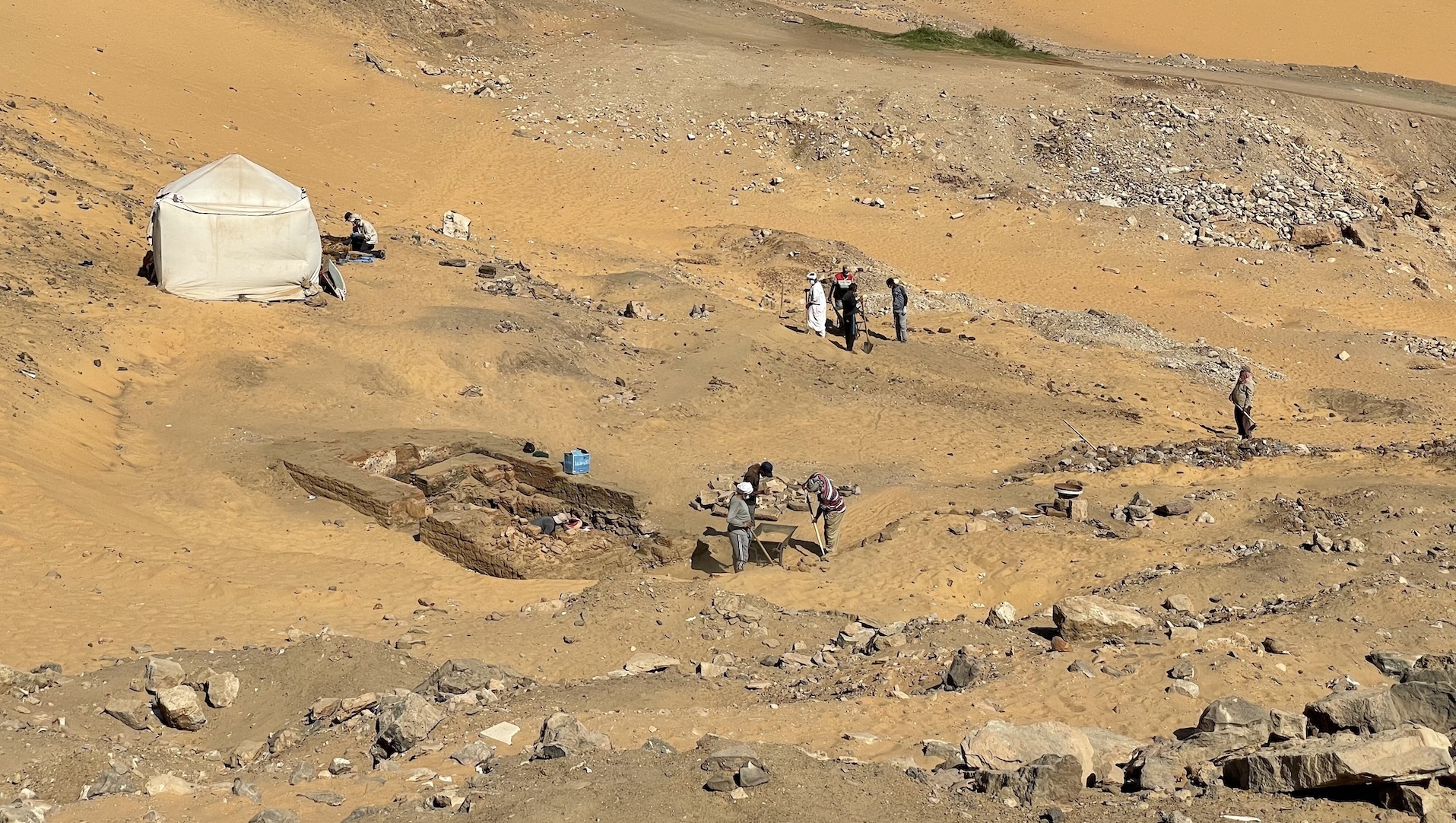 Archaeologists surveying the necropolis area on the hillside of Aswan.