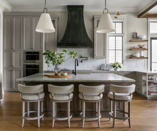 Gray kitchen with large island and white pendant lights