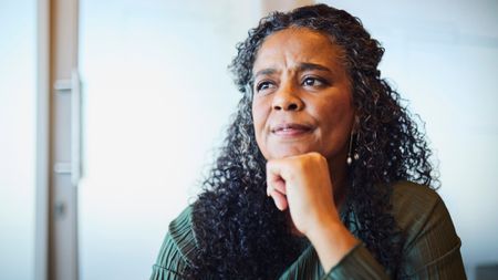 Thoughtful Mature Businesswoman with Hand on Chin
