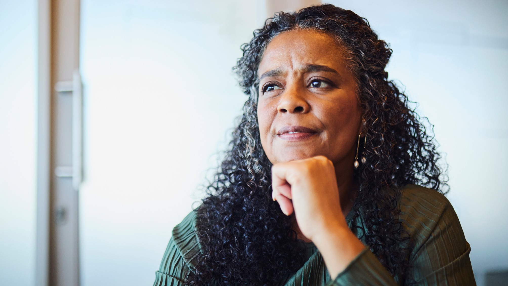 Thoughtful Mature Businesswoman with Hand on Chin