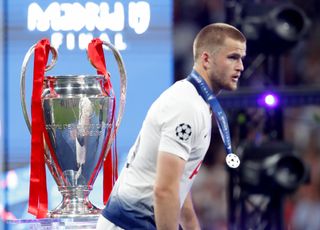 Eric Dier walks past the trophy with his runner-up medal