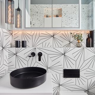 Bathroom with geometric black and white tiles behind sink