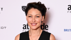 Image of Emma Willis smiling with brunette pixie cut and wearing a black waistcoat, with a white background with text on it