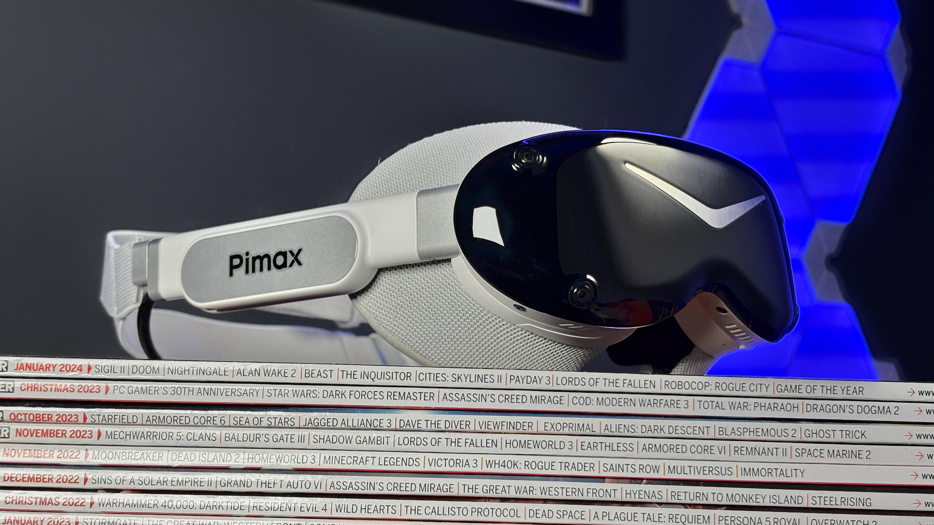 The Pimax Dream Air in white on a stack of PC Gamer magazine.