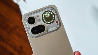 A leveler Glyph Toy on the Glyph Matrix display on the back of a silver Nothing Phone 4a Pro