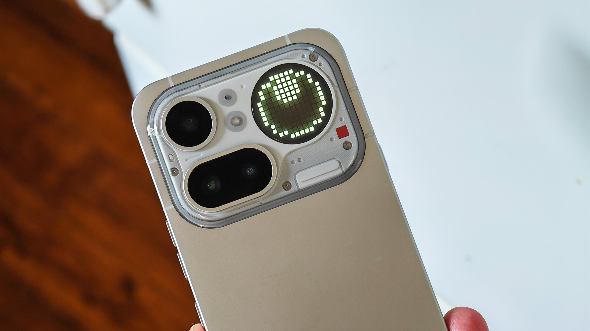 A leveler Glyph Toy on the Glyph Matrix display on the back of a silver Nothing Phone 4a Pro