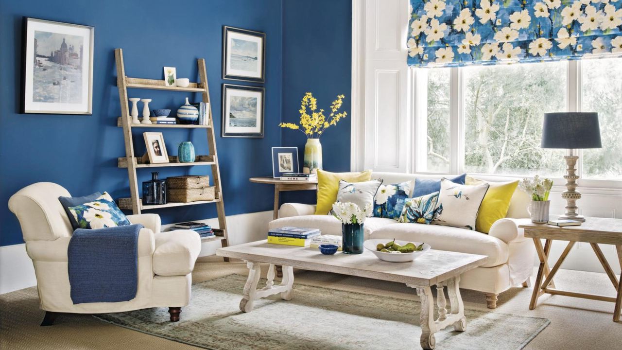 A calm and decluttered living room, painted in French blue