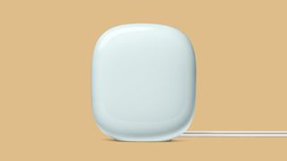 White Google Nest WiFi Pro on beige background