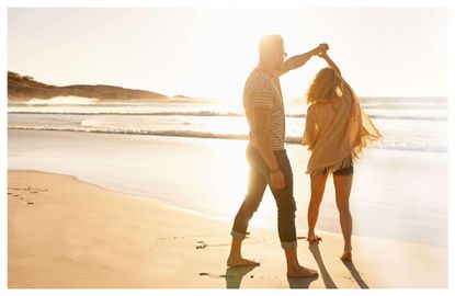 A couple dancing on the beach at sunset, symbolizing healing and connection in relationships.