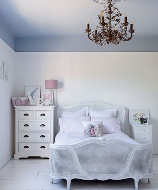 Kids room with pale blue painted ceiling and chandelier in Georgian home