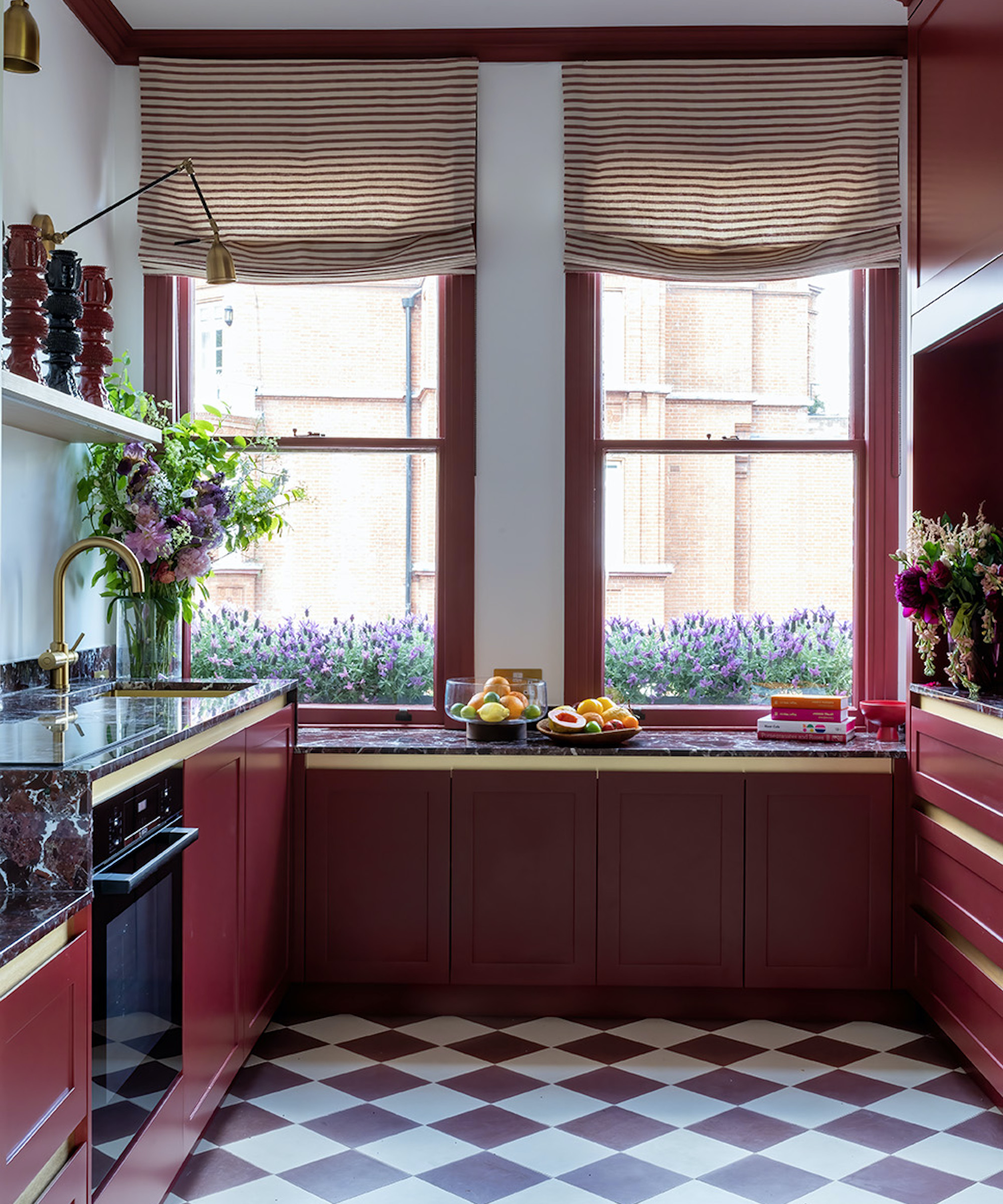 red kitchen cabinets with red and white floor tiles