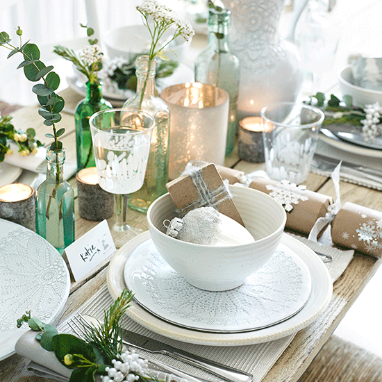 christmas table with dinnerware and display foliage