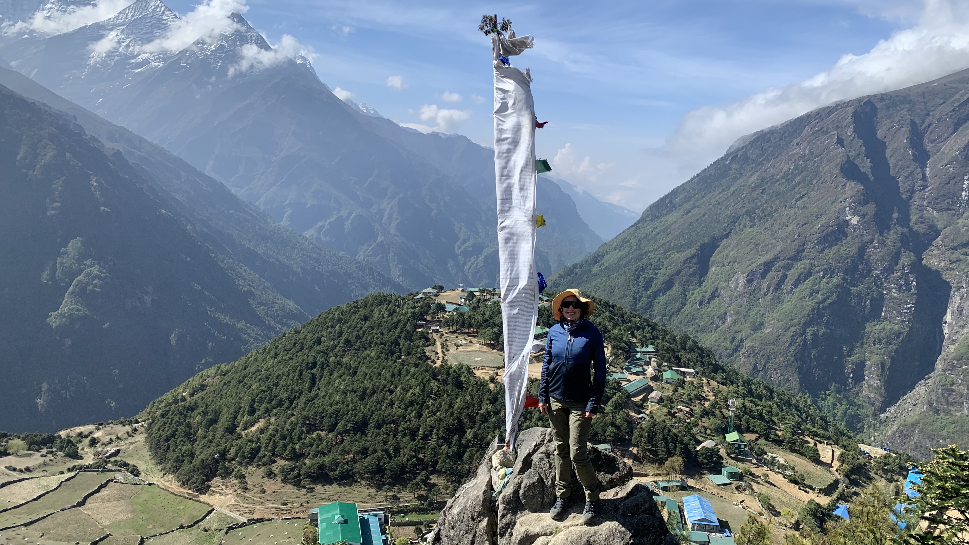 Juia Clarke standing on a rock in the Himalayas