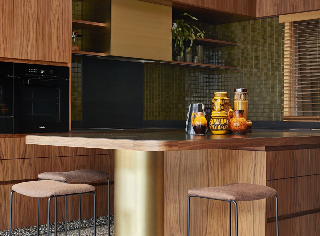 A mid-century modern kitchen with a &#039;70s color palette, tiling, panelling and terrazzo 