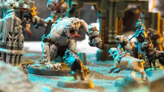 Warcry: Hunter and Hunted ogres stare down the hounds on a battlefield