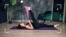 Woman stretching out with a resistance band at home in studio after learning how to do resistance band exercises