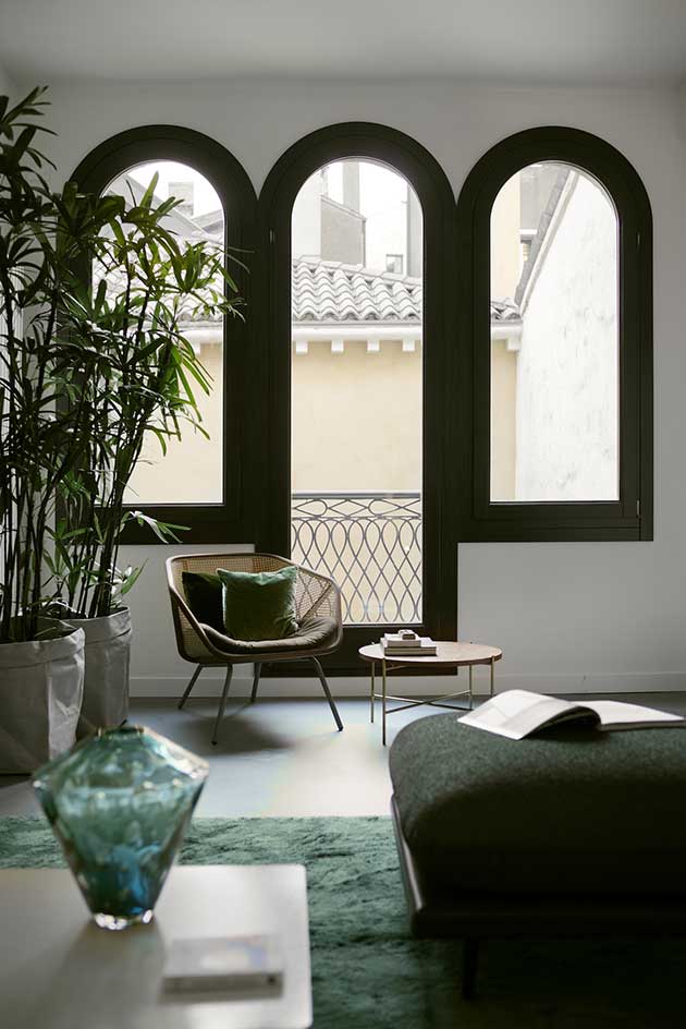 Arch style windows open up to balcony in lounge