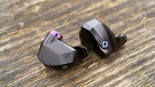 Campfire Audio Fathom earbuds without cable, on a brown table