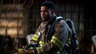Jordan Calloway as Jake sitting in his fire gear in Fire Country