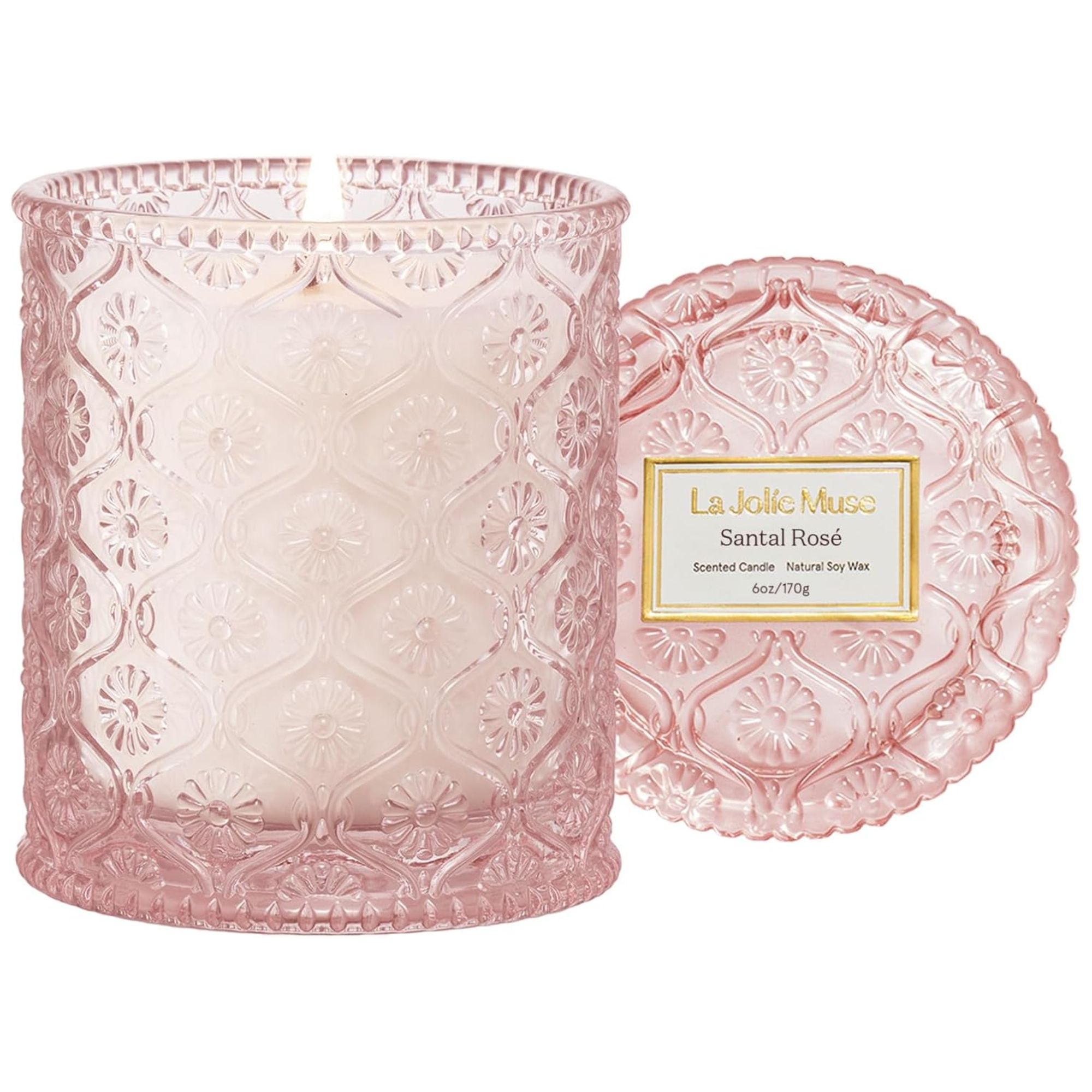La Jolie Muse Santal Rose candle in a pale pink glass vessel with an etched patterned design and lid