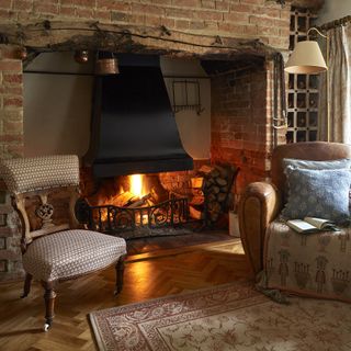 snug with fire lit in 17th century thatched cottage