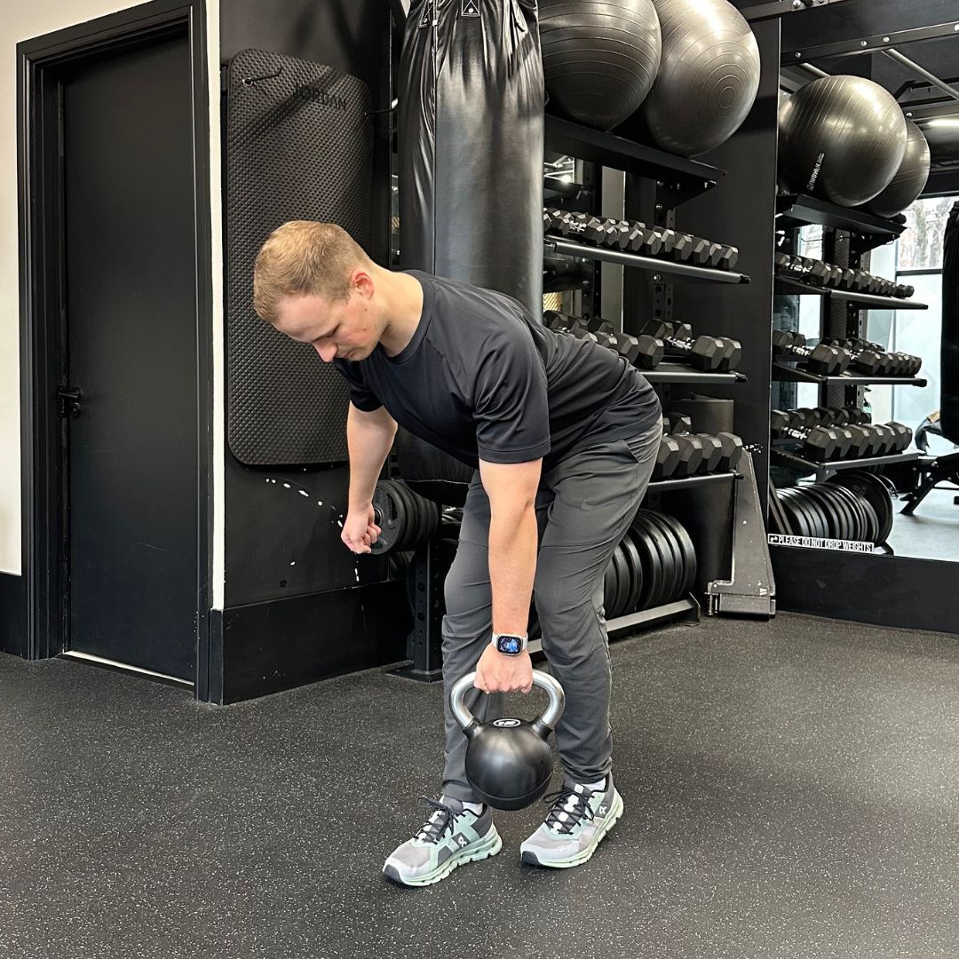 Personal trainer Ollie Thompson demonstrating a B-stance single-leg deadlift