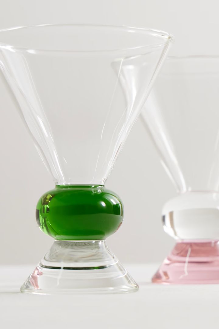 + Ghia Totem Set of Two Glasses with green and pink glass inserts against pale white background.