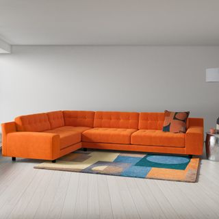 living area with l shape orange big sofa set