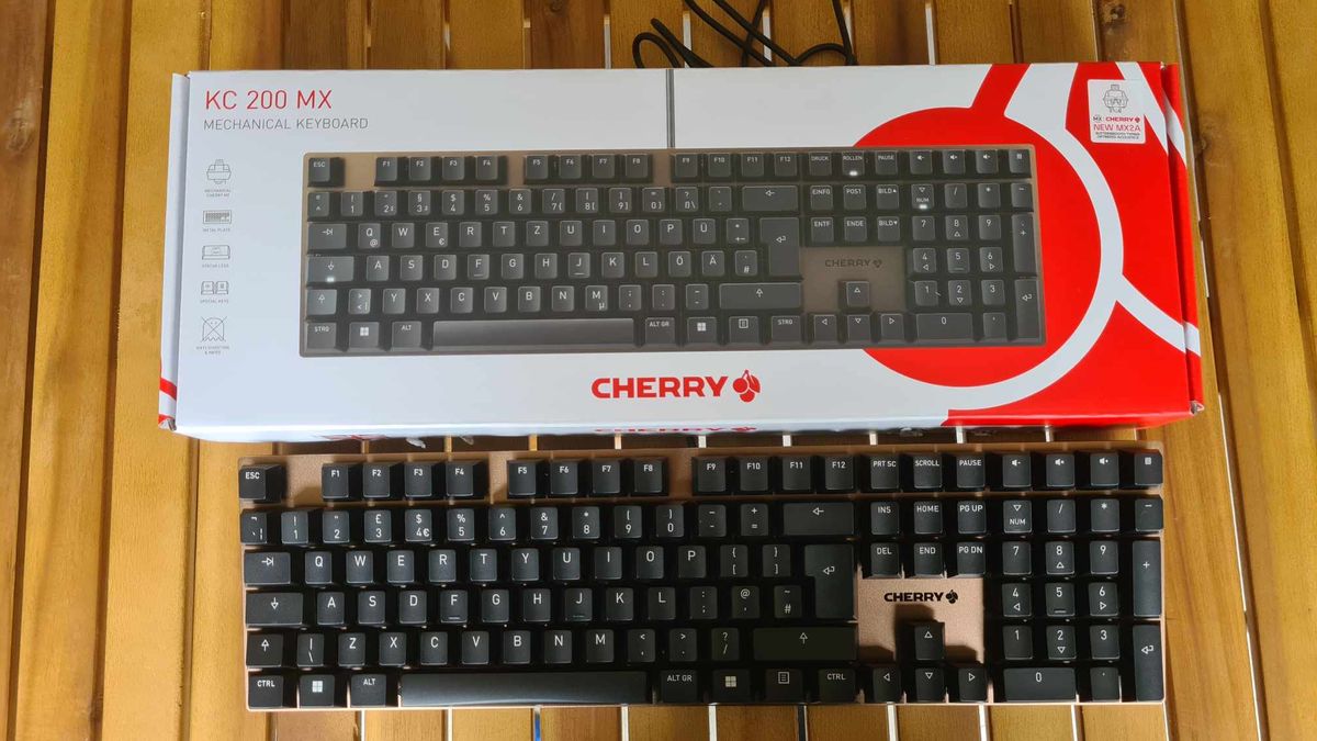 Cherry KC 200 MX gaming keyboard on a wooden table.