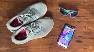 a photo of the stride app with some running shoes 