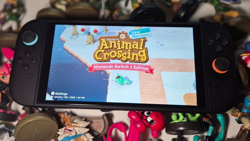 Photo of a Nintendo Switch 2 sitting on a pile of Zelda and Splatoon amiibo figures while running Animal Crossing New Horizons.