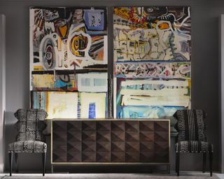 A modern hallway idea with dark wood sideboard and large abstract paintings