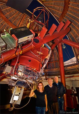 Frank Drake, center, with his colleagues, Optical SETI (OSETI) Principal Investigator Shelley Wright and Rem Stone with the 40-inch Nickel telescope at Lick Observatory in California. Outfitted with the OSETI instrument, the silver rectangular instrument package protrudes from the bottom of the telescope, plus computers, etc.