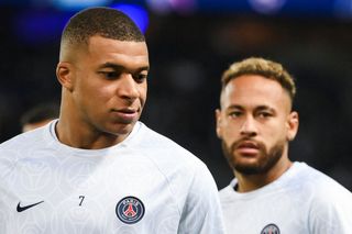 Paris Saint-Germain's French forward Kylian Mbappe (L) and Brazilian forward Neymar (R) warm up prior to the UEFA Champions League group H football match between Paris Saint-Germain (PSG) and SL Benfica, at The Parc des Princes Stadium, on October 11, 2022.