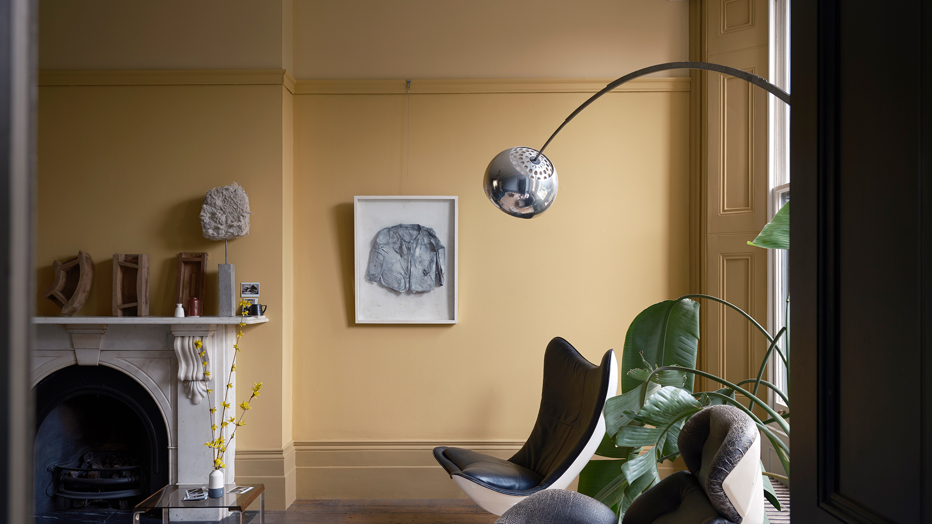 yellow living room with contemporary egg armchairs