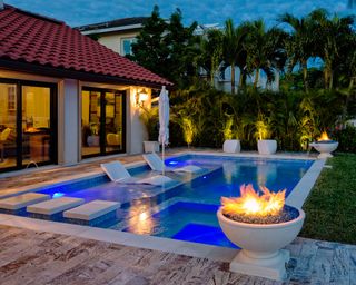 outdoor modern pool with fire features