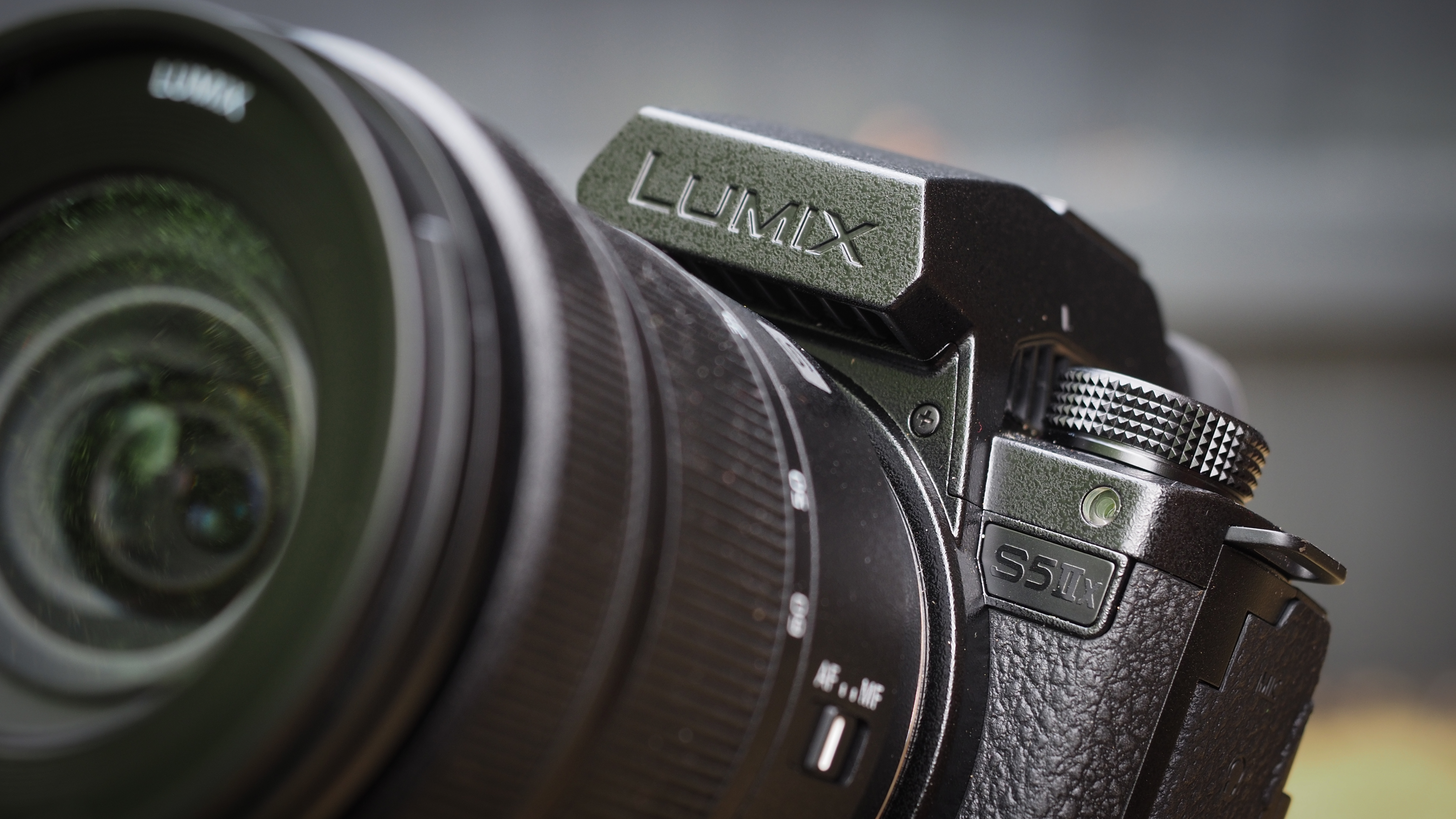 Close up view of the Panasonic Lumix S5 IIX badge and mode dial