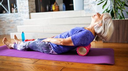Woman using one of the best foam rollers at home