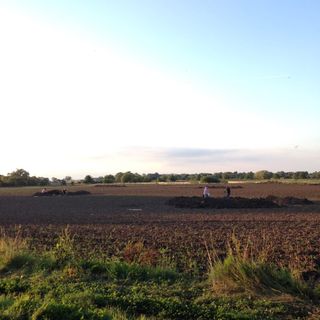 Archaeologists excavate in plowed fields near the village of Little Carlton in Lincolnshire, England.