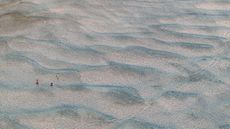People cross newly exposed sandbanks on the Danube River as water levels fall during prolonged dry conditions in Apatin, Serbia