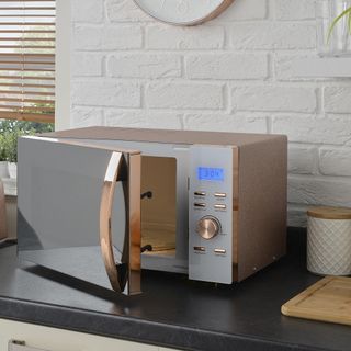 kitchen area with rose gold microwave