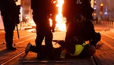 Riot police arrest a protestor during violent demonstrations in France