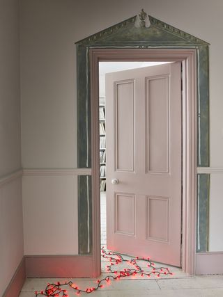 pink hallway with coloured skirting board and internal door