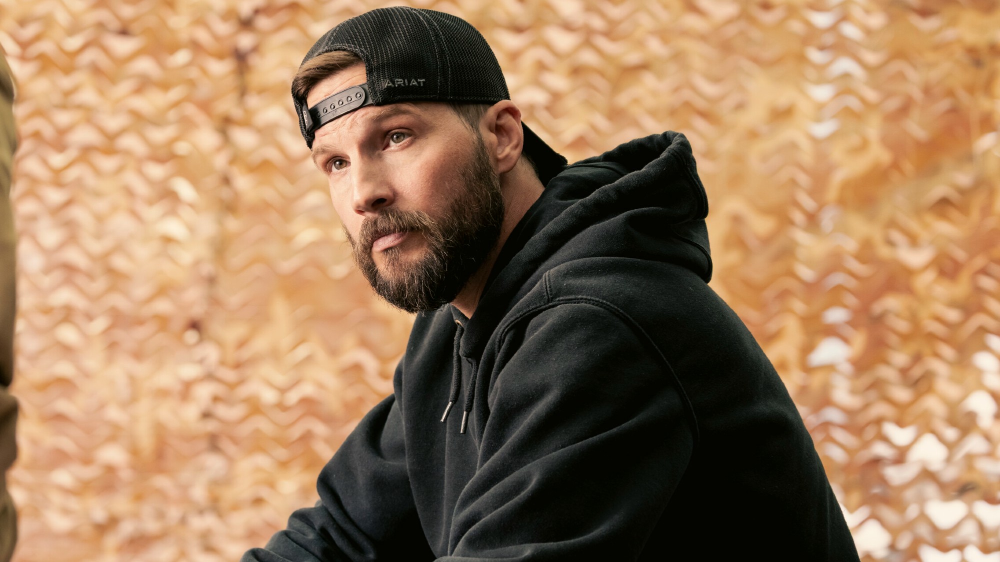 Logan Marshall-Green leaning and looking up in Marshals. 