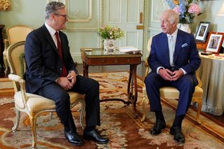 Britain's King Charles III (R) meets with Britain's incoming Prime Minister Keir Starmer during an audience at Buckingham Palace in London on July 5, 2024