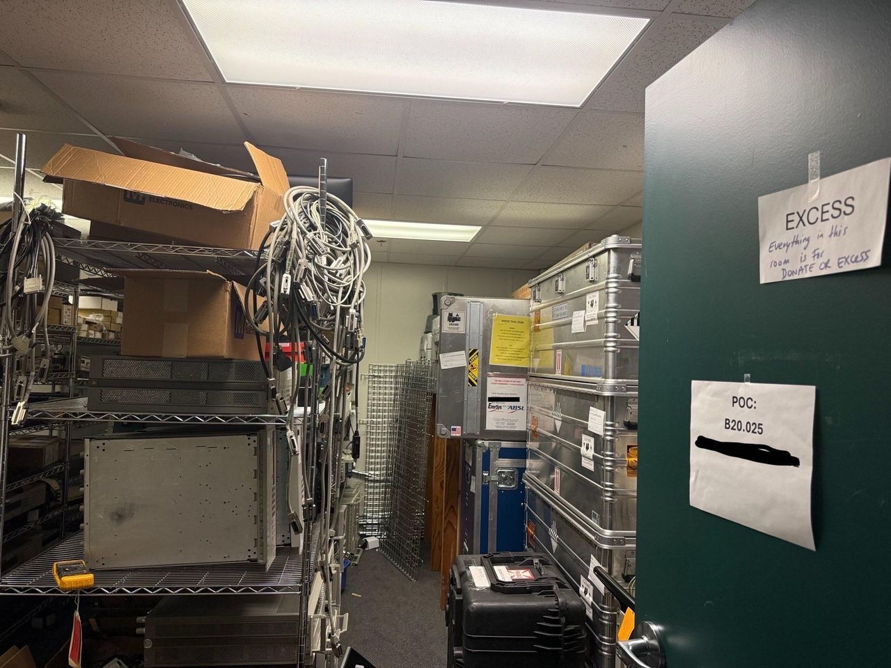 Various office spaces including desks, shelves and warehouses full of items stacked ready to be removed.